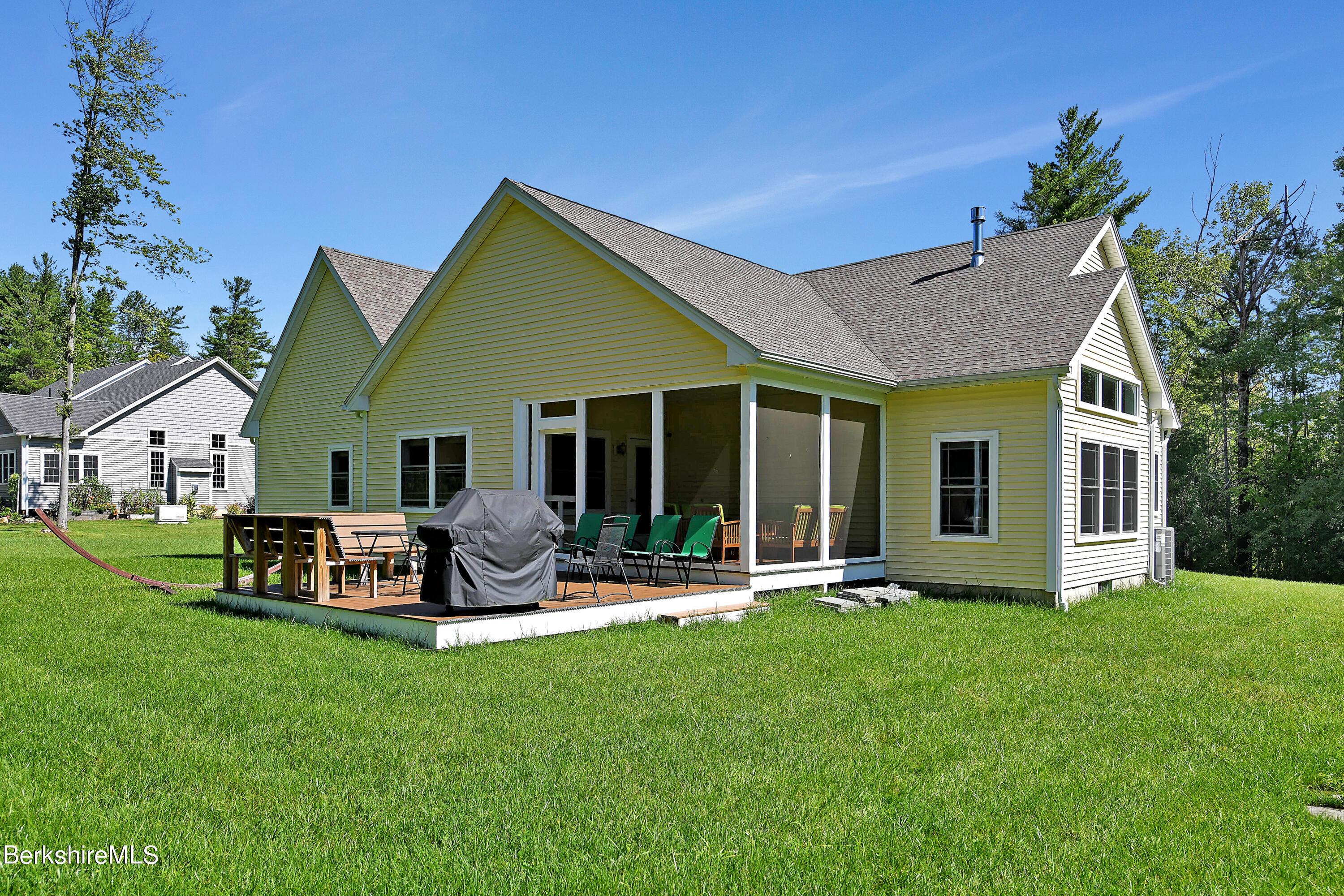 583 W Road Lee, MA 01238 - Photo 25 of 37 a front view of house with a garden and patio
