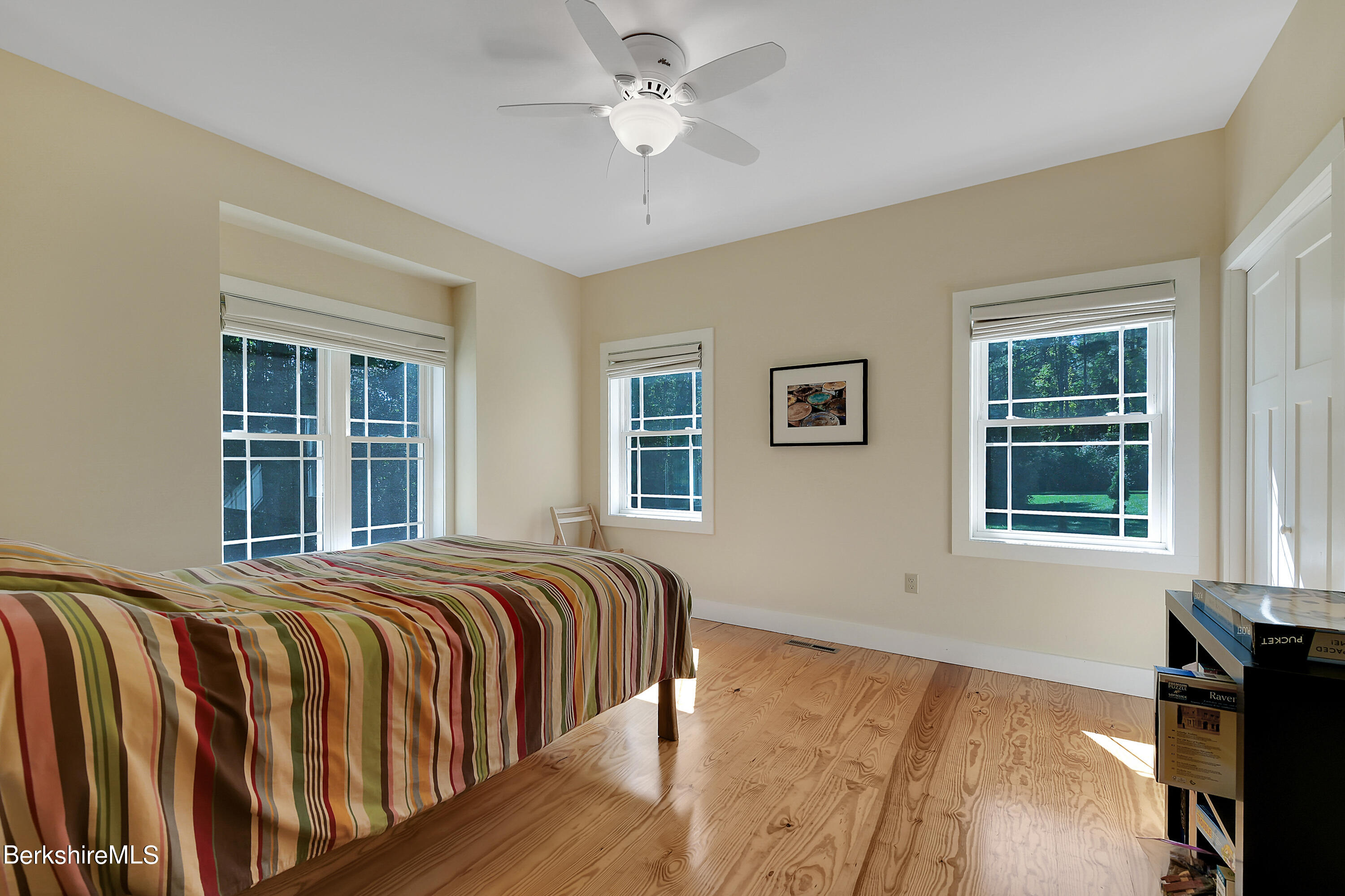 583 W Road Lee, MA 01238 - Photo 26 of 37 a bedroom with a bed and wooden floor