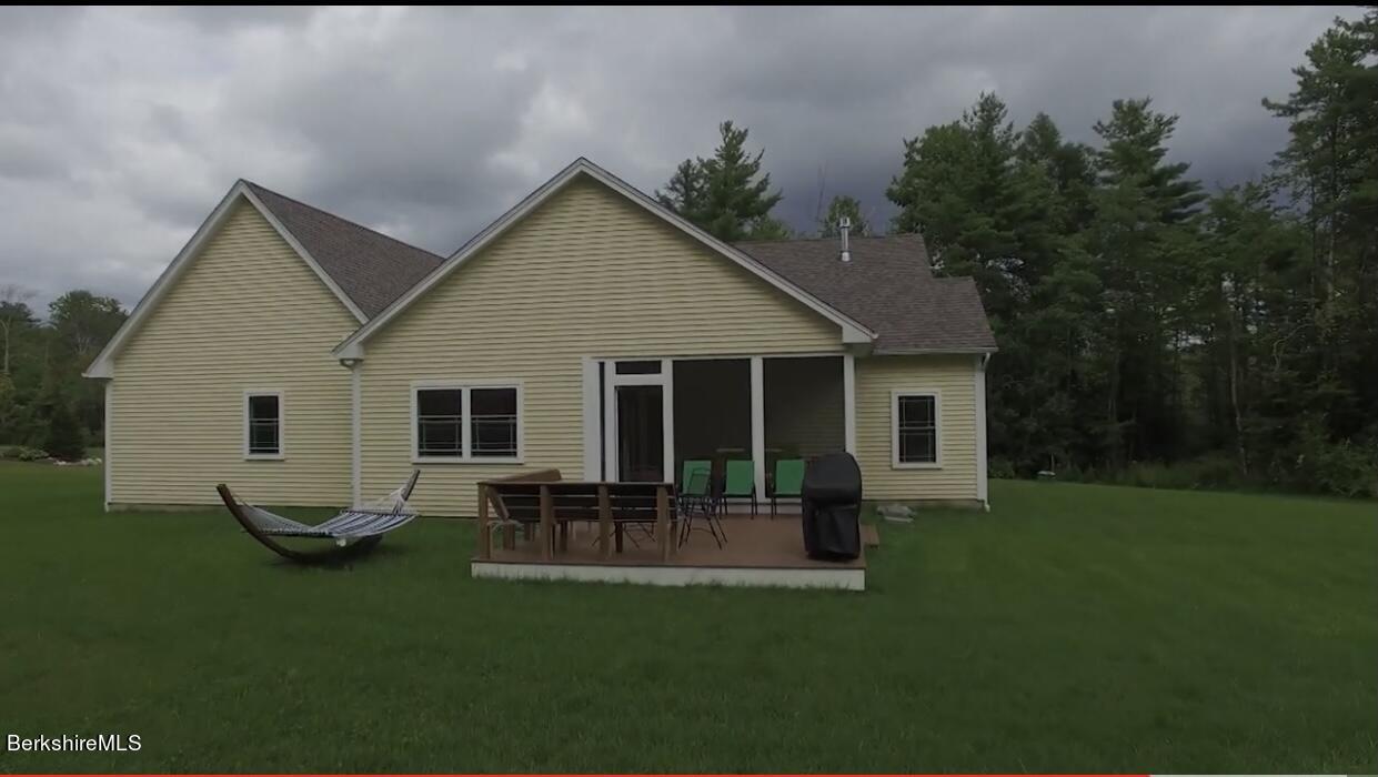 583 W Road Lee, MA 01238 - Photo 33 of 37 a view of a house with backyard sitting area and garden