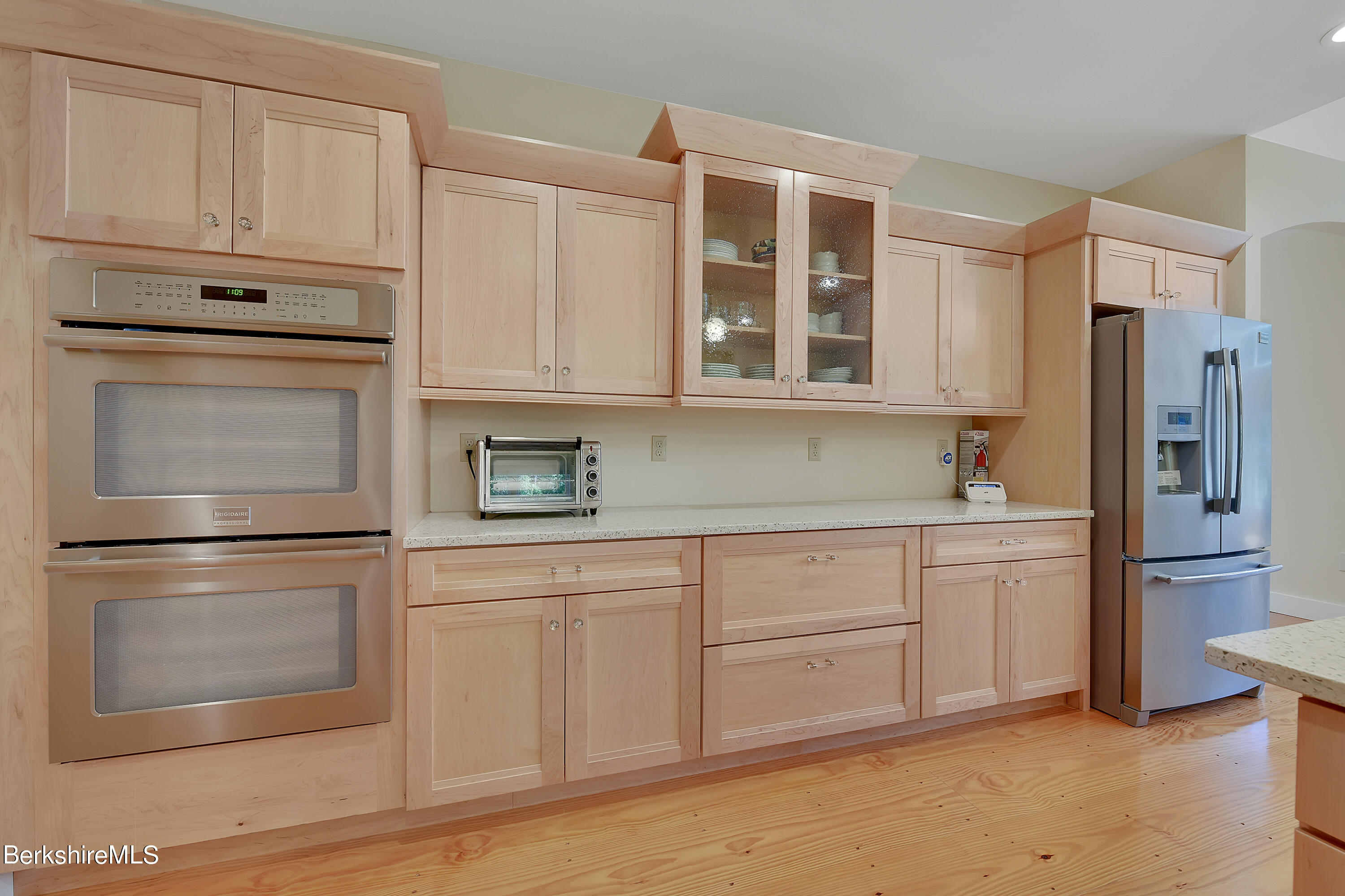 583 W Road Lee, MA 01238 - Photo 6 of 37 a kitchen with stainless steel appliances granite countertop a refrigerator stove and white cabinets
