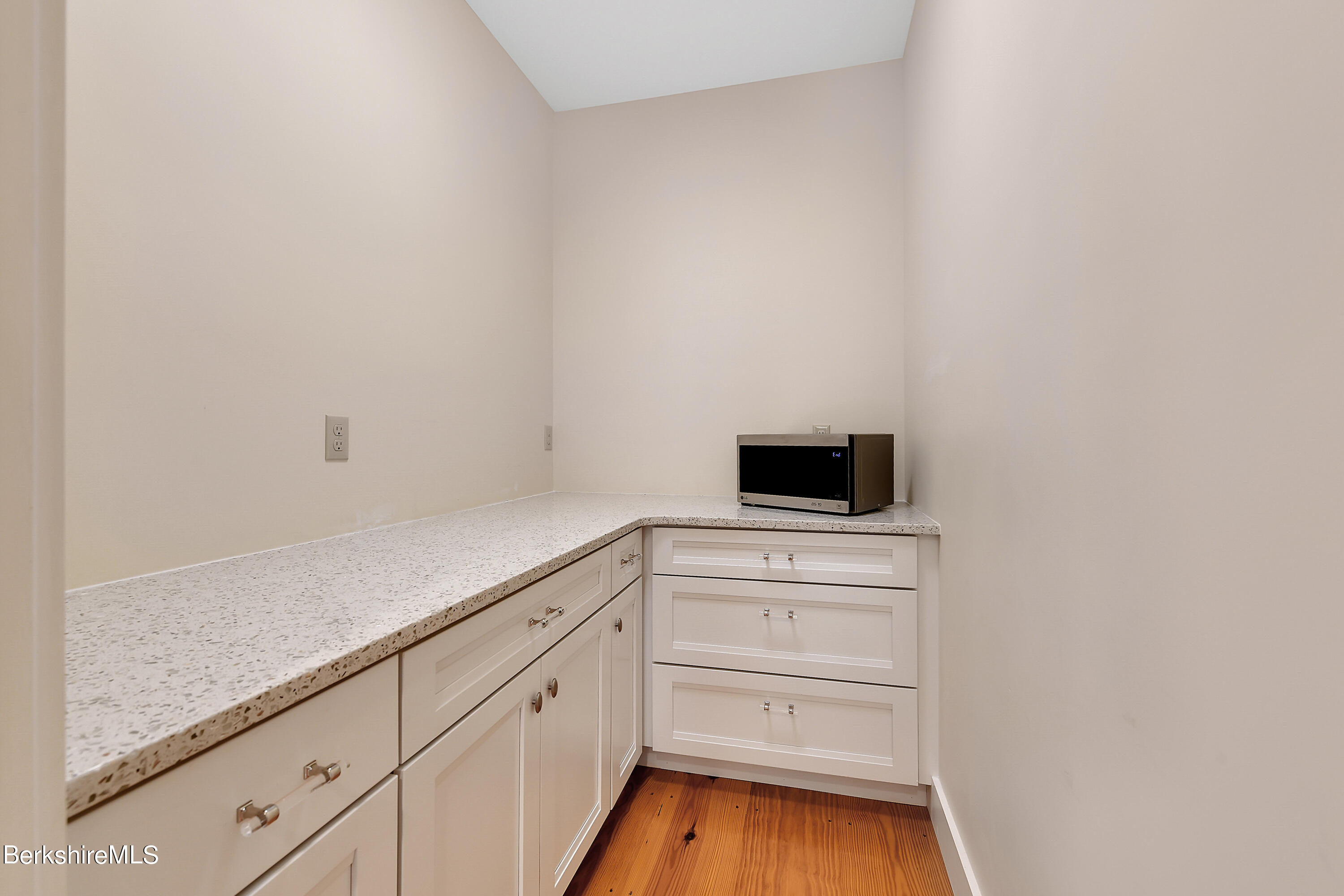 583 W Road Lee, MA 01238 - Photo 9 of 37 a kitchen with white cabinets and sink