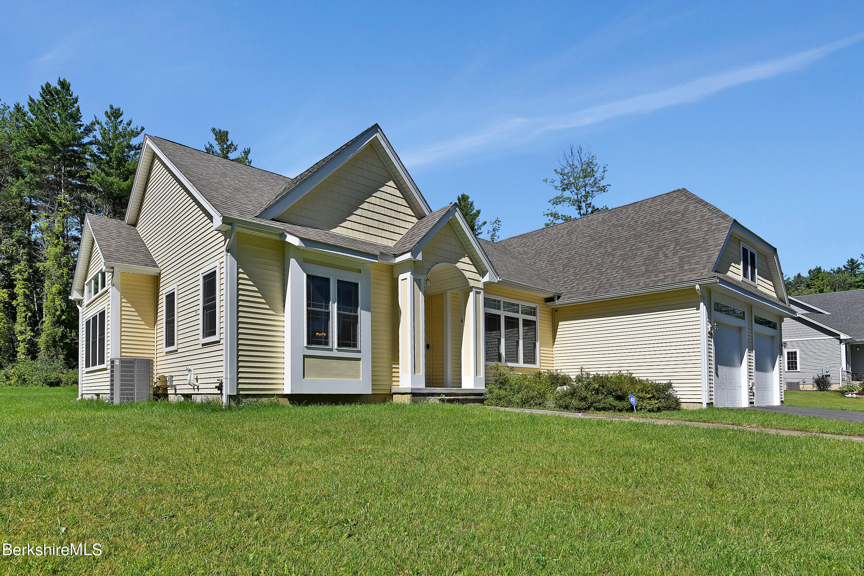 583 W Road Lee, MA 01238 - Photo 10 of 37 a front view of a house with a garden