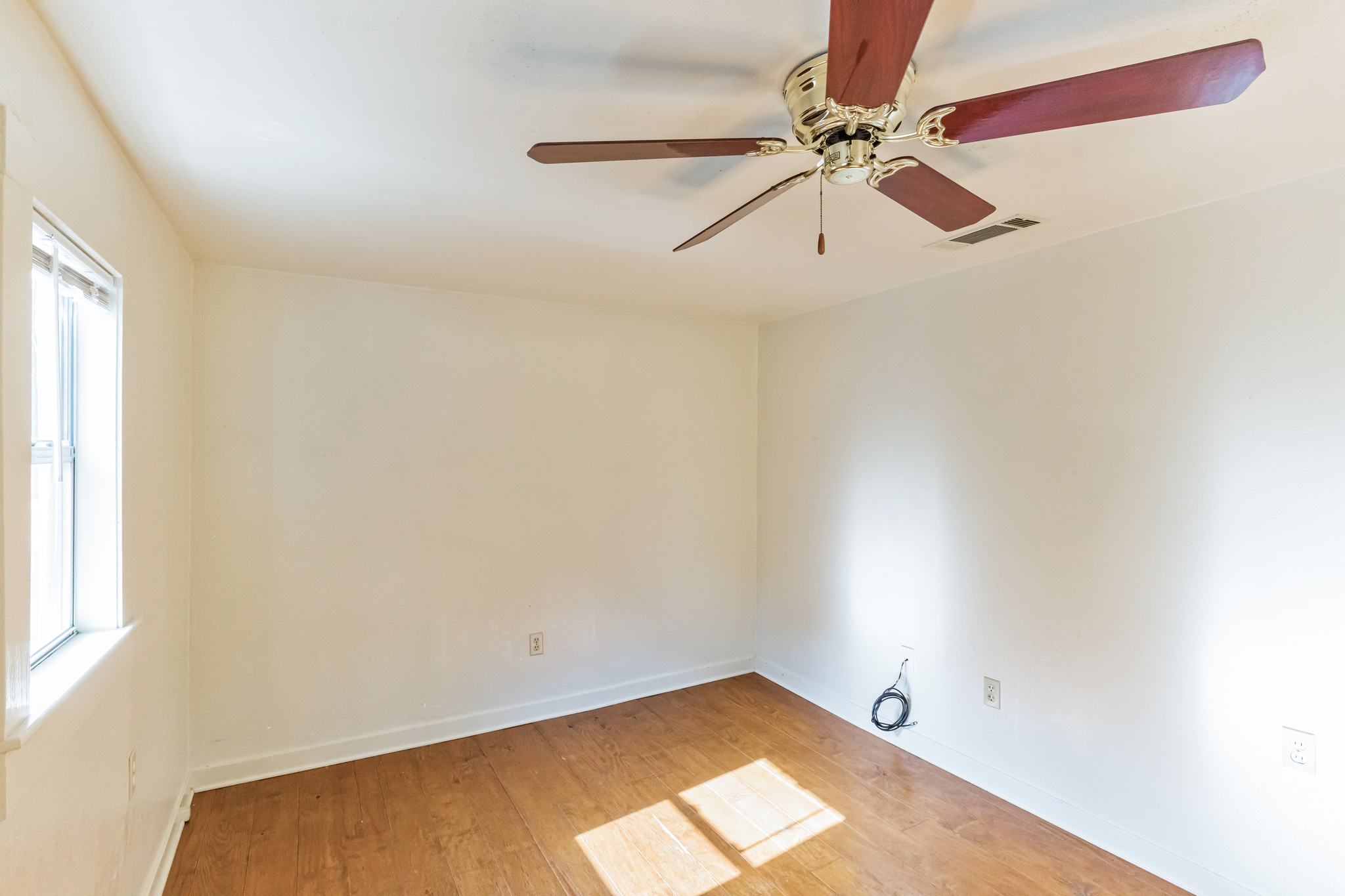 501 East 4th Street Georgetown, TX 78626 - Photo 16 of 25 an empty room with windows and fan