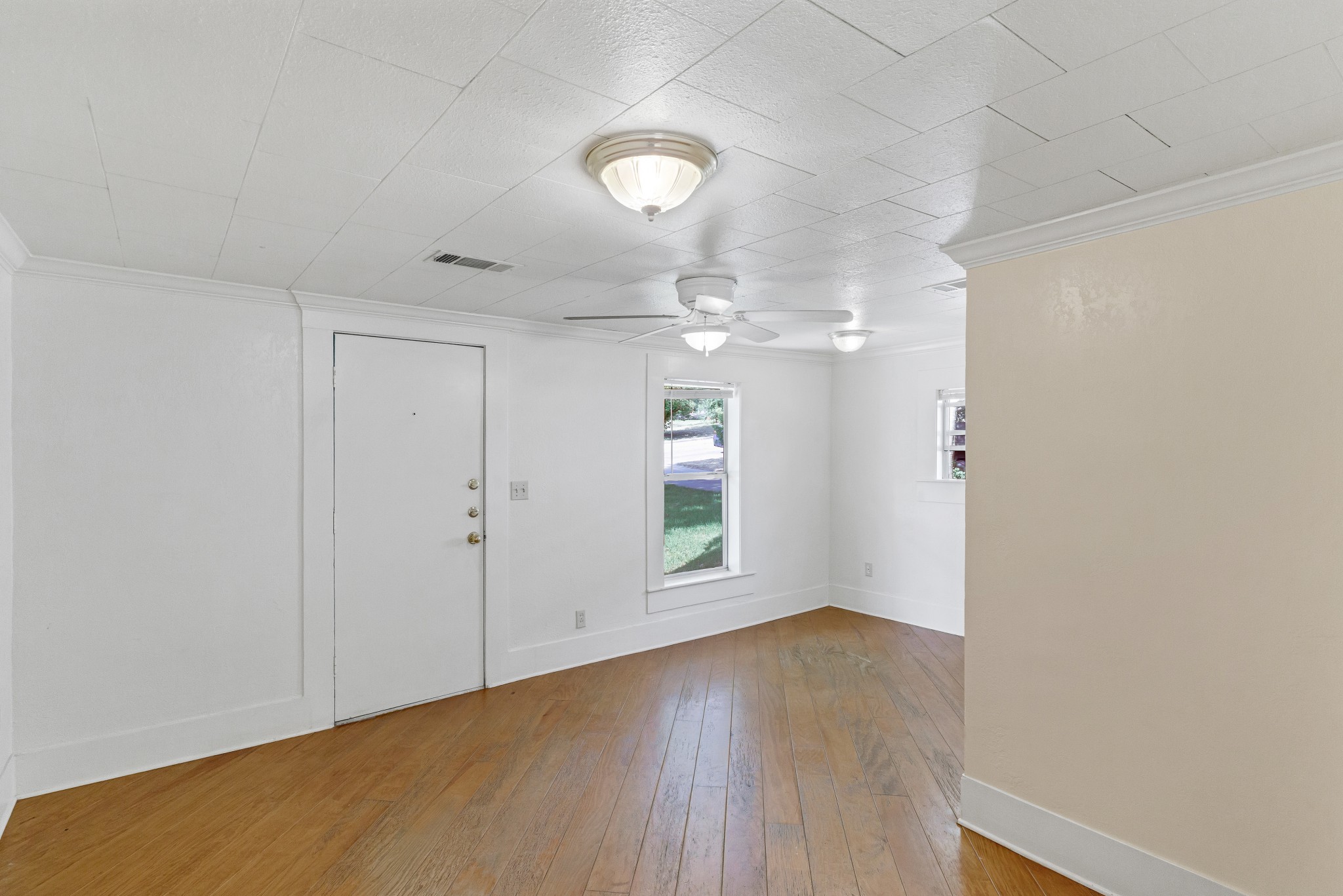 501 East 4th Street Georgetown, TX 78626 - Photo 6 of 25 an empty room with wooden floor and windows