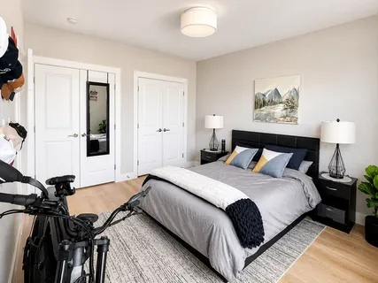 a spacious bedroom with a bed and a chandelier