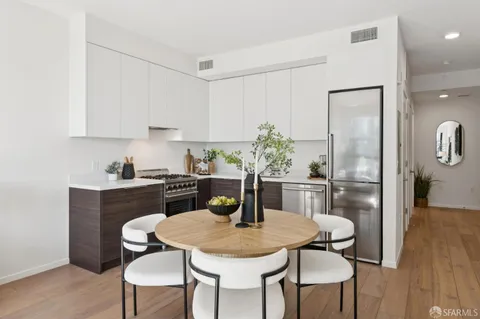 a kitchen with a table and chairs in it