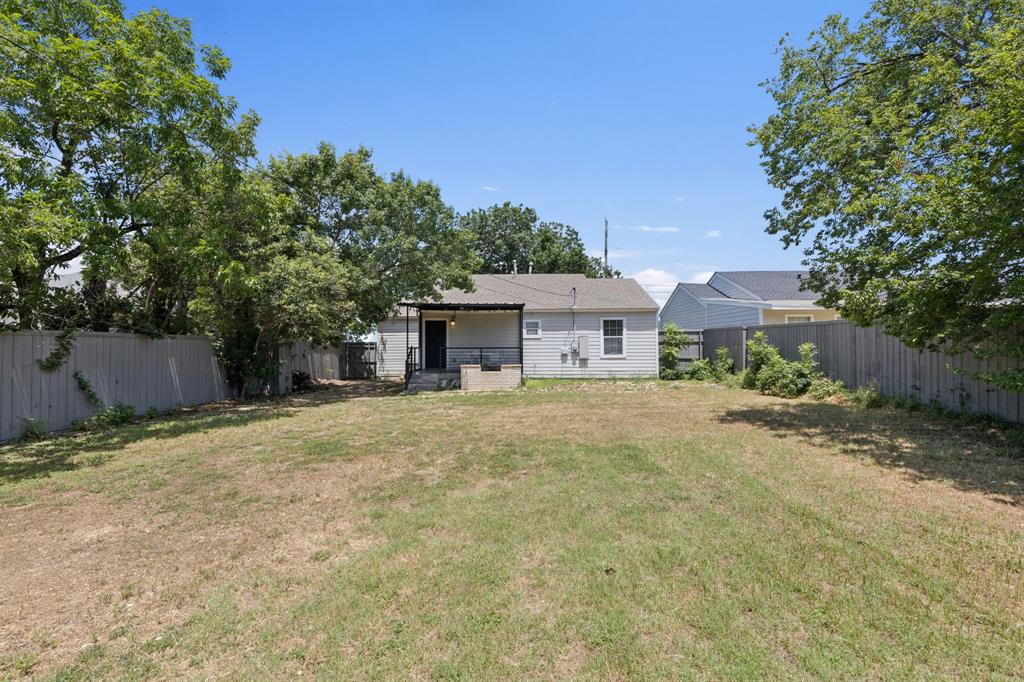 3222 Inwood Road Dallas, TX 75235 - Photo 23 of 25 a front view of a house with a yard and a garage