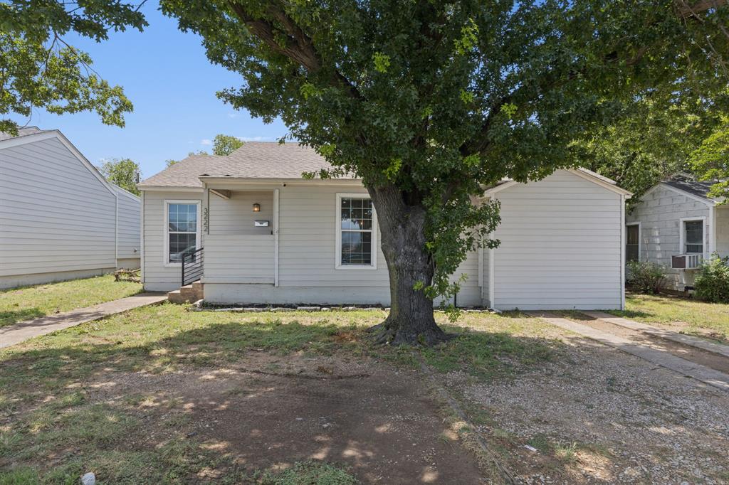 3222 Inwood Road Dallas, TX 75235 - Photo 25 of 25 a view of a house with a yard and garage