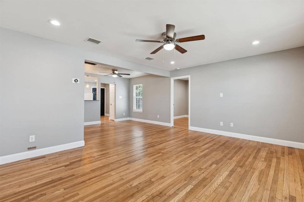 3222 Inwood Road Dallas, TX 75235 - Photo 6 of 25 a view of empty room with wooden floor and fan