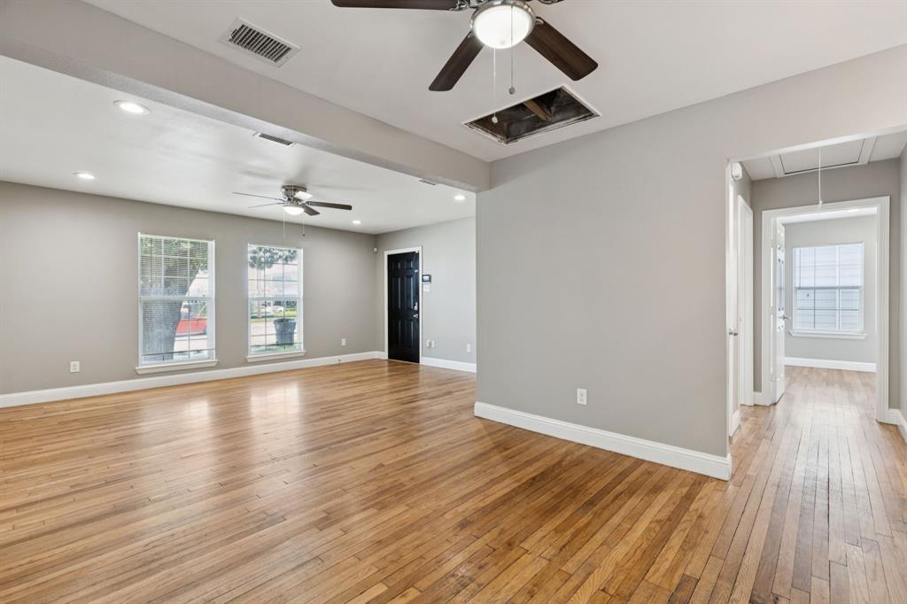 3222 Inwood Road Dallas, TX 75235 - Photo 8 of 25 a view of an empty room with wooden floor and a window