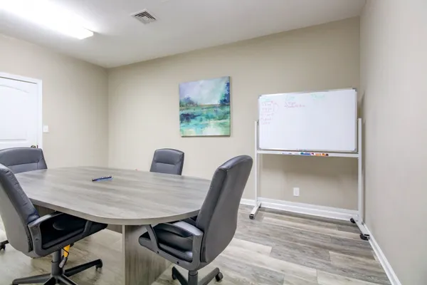 a view of a workspace with furniture and wooden floor