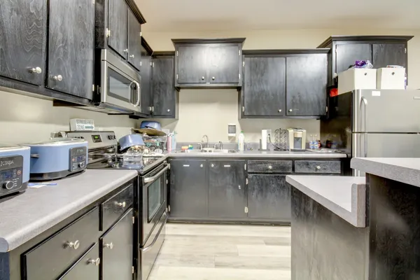 a kitchen with a sink a stove and refrigerator
