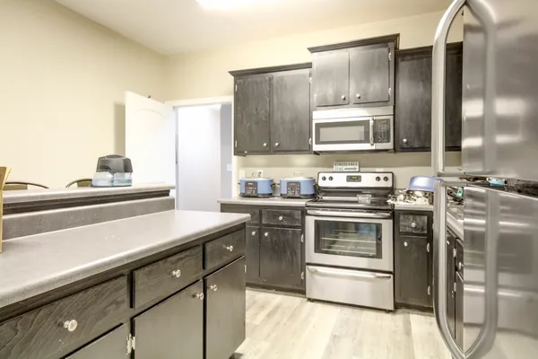 a kitchen with stainless steel appliances a stove sink and cabinets