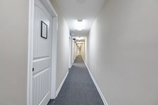 a view of a hallway with wooden floor