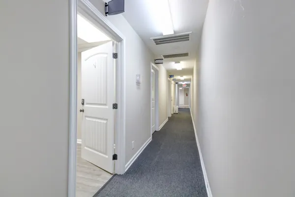 a view of a hallway with white walls