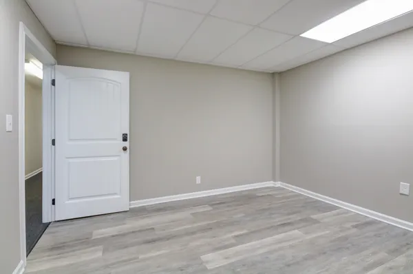 a view of a room with wooden floor