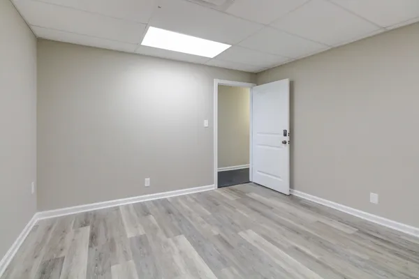 a view of an empty room with wooden floor