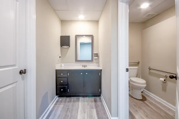 a bathroom with a sink a toilet and shower