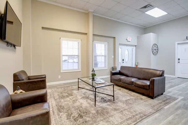 a living room with furniture and a flat screen tv