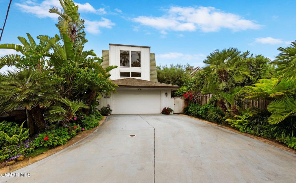 a pathway of a house with a yard