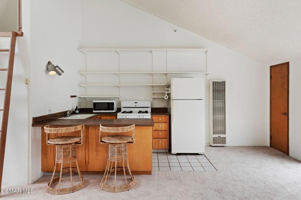 3523 Padaro Lane Carpinteria, CA 93013 - Photo 5 of 14 a kitchen with stainless steel appliances a refrigerator a stove a sink and a refrigerator