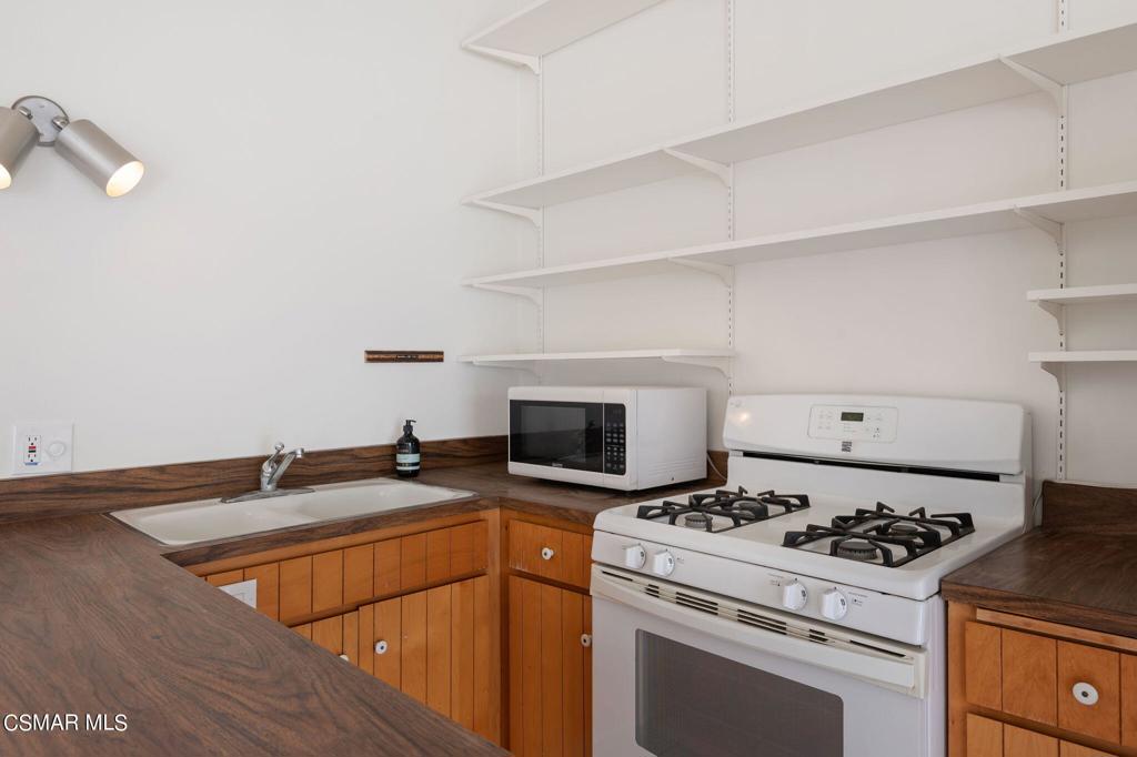 3523 Padaro Lane Carpinteria, CA 93013 - Photo 6 of 14 a kitchen with a stove a sink and a microwave