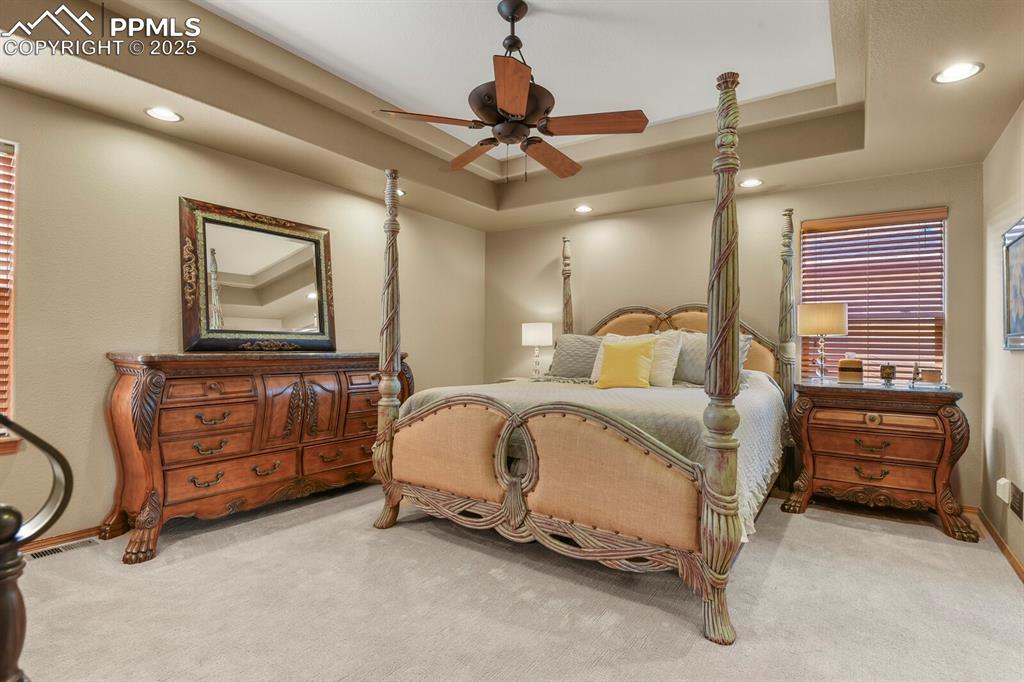 2563 Integrity Court Colorado Springs, CO 80918 - Photo 16 of 49 a bedroom with a bed and a chandelier