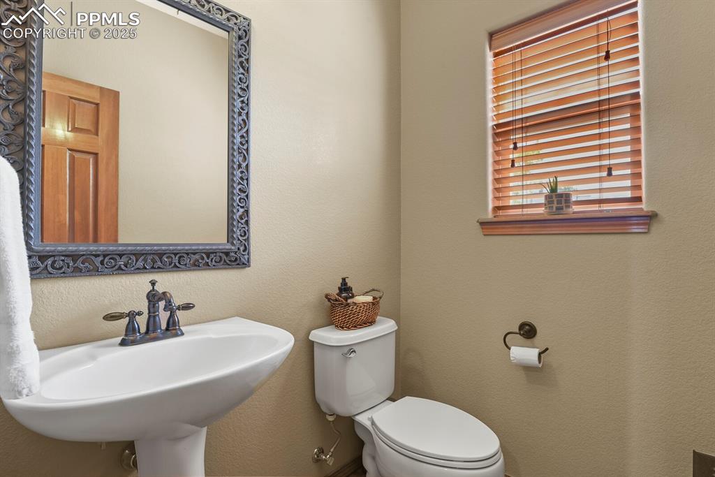 2563 Integrity Court Colorado Springs, CO 80918 - Photo 22 of 49 a bathroom with a sink a mirror and a toilet
