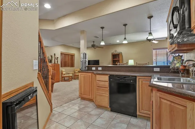 a kitchen with cabinets and chairs