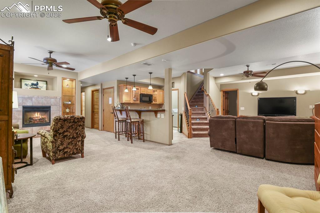 2563 Integrity Court Colorado Springs, CO 80918 - Photo 29 of 49 a living room with furniture and a flat screen tv