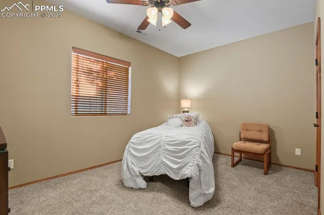 a bedroom with a bed and a chair