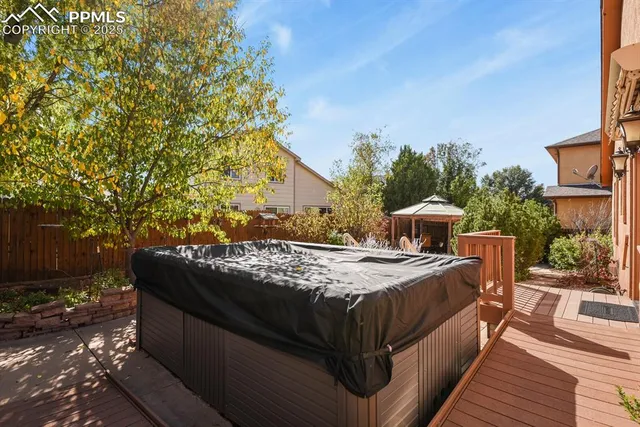 a bed sitting in a spacious bedroom next to a yard