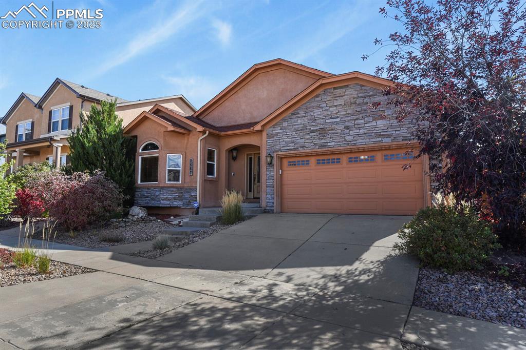 2563 Integrity Court Colorado Springs, CO 80918 - Photo 4 of 49 a front view of a house with a yard and garage