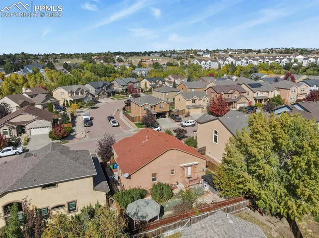an aerial view of residential houses with outdoor space