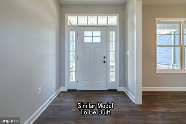 an empty room with wooden floor painted walls and windows