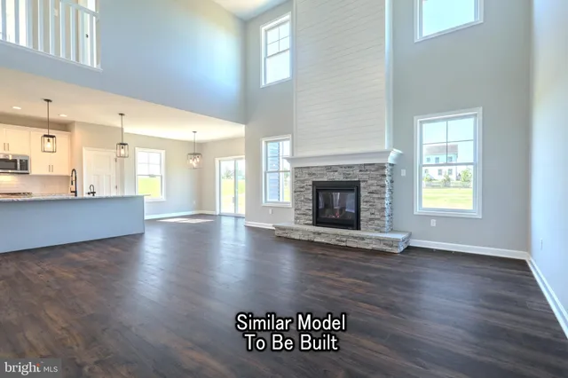 a view of a kitchen with furniture and wooden floor