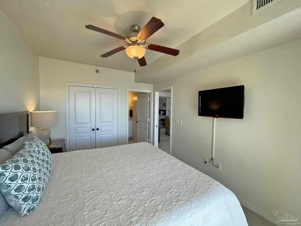 a bedroom with a bed and a flat screen tv
