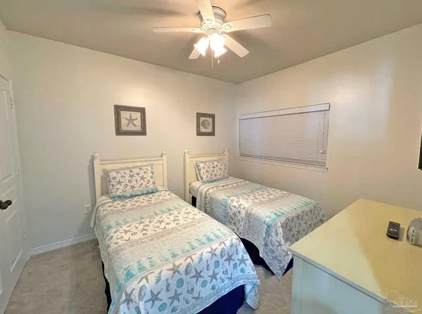 a bedroom with two beds and a table