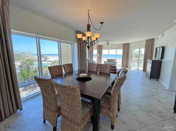 a view of a dining room with furniture wooden floor and chandelier