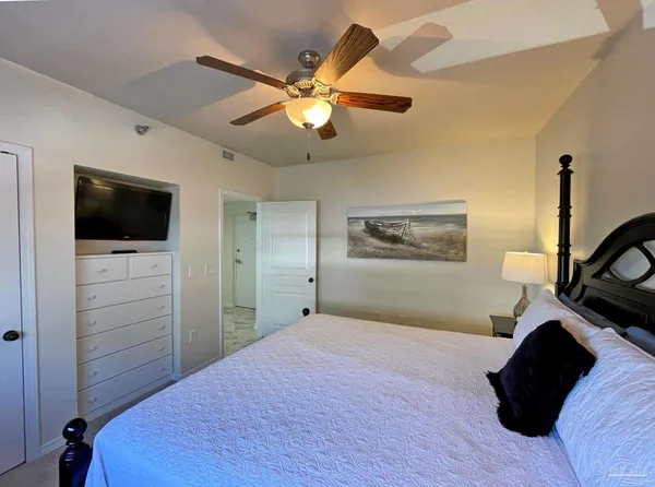 a bedroom with a bed and a flat screen tv