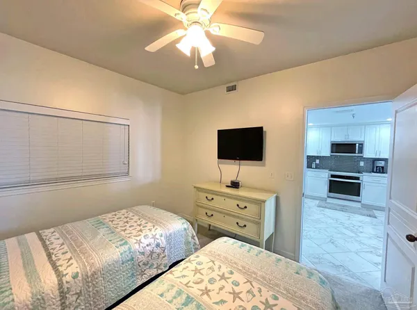 a bedroom with a bed and a flat screen tv
