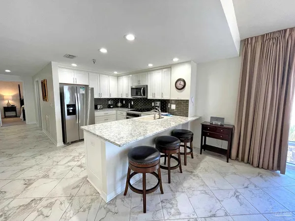 a large kitchen with a table and chairs