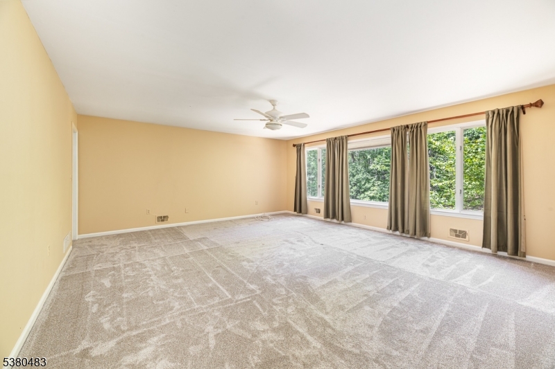 11 Indian Hollow Road Mendham, NJ 07945 - Photo 12 of 26 a view of a livingroom with a ceiling fan and window