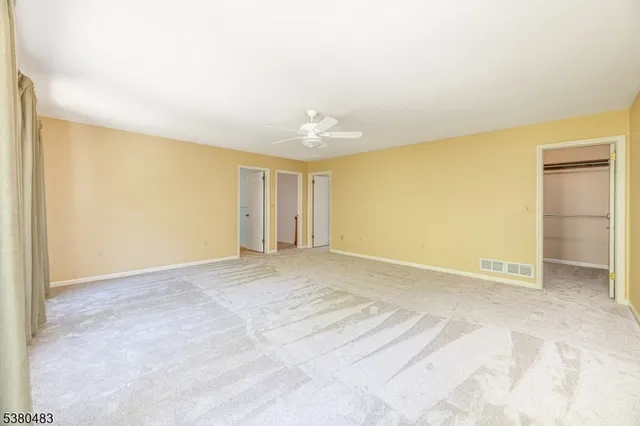 a spacious bathroom with a double vanity sink toilet mirror and bathtub