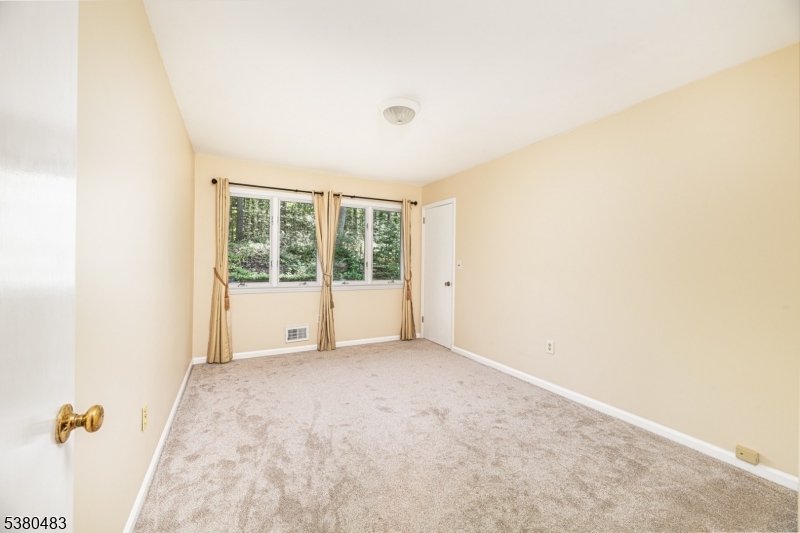 11 Indian Hollow Road Mendham, NJ 07945 - Photo 16 of 26 a view of an empty room with a window