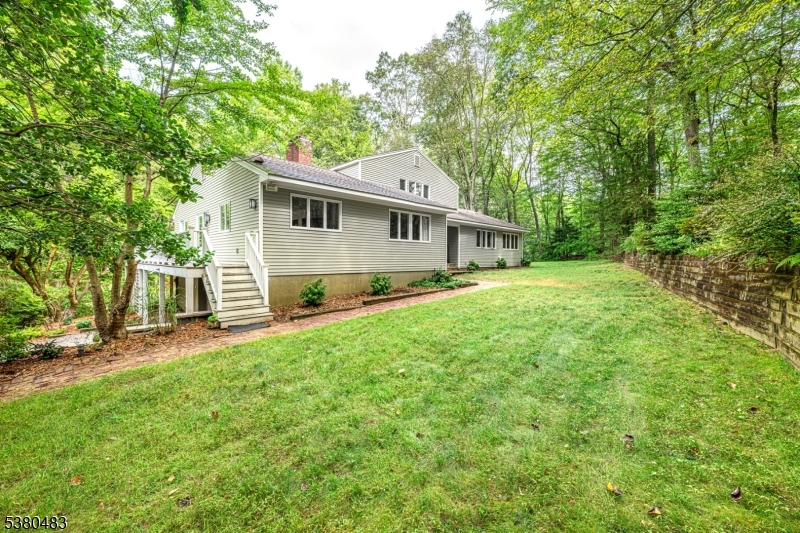 11 Indian Hollow Road Mendham, NJ 07945 - Photo 21 of 26 a front view of a house with a yard