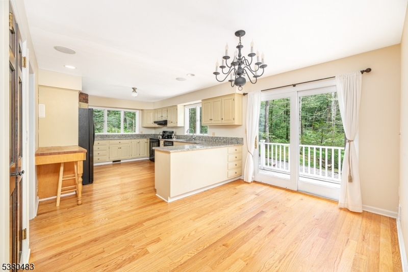 11 Indian Hollow Road Mendham, NJ 07945 - Photo 5 of 26 a large white kitchen with wooden floors and wide window