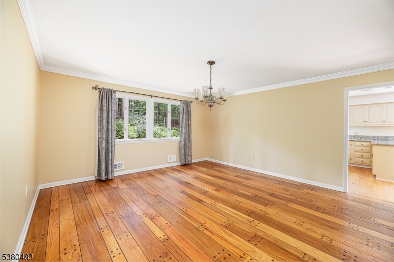 11 Indian Hollow Road Mendham, NJ 07945 - Photo 6 of 26 a view of empty room with wooden floor and fan