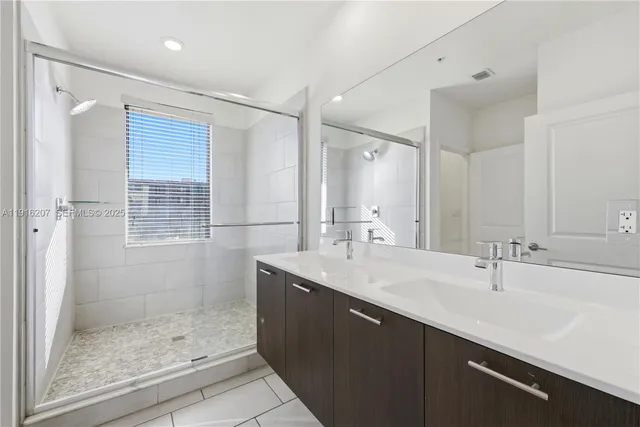 a bathroom with a shower sink and mirror