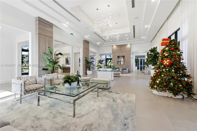 a living room with furniture and a chandelier